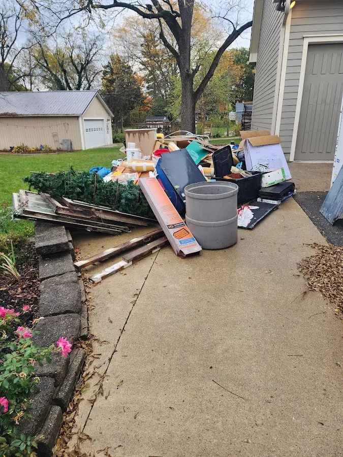 Dumpster being loaded with debris for 12 Yard Dumpster Rental in Pocola